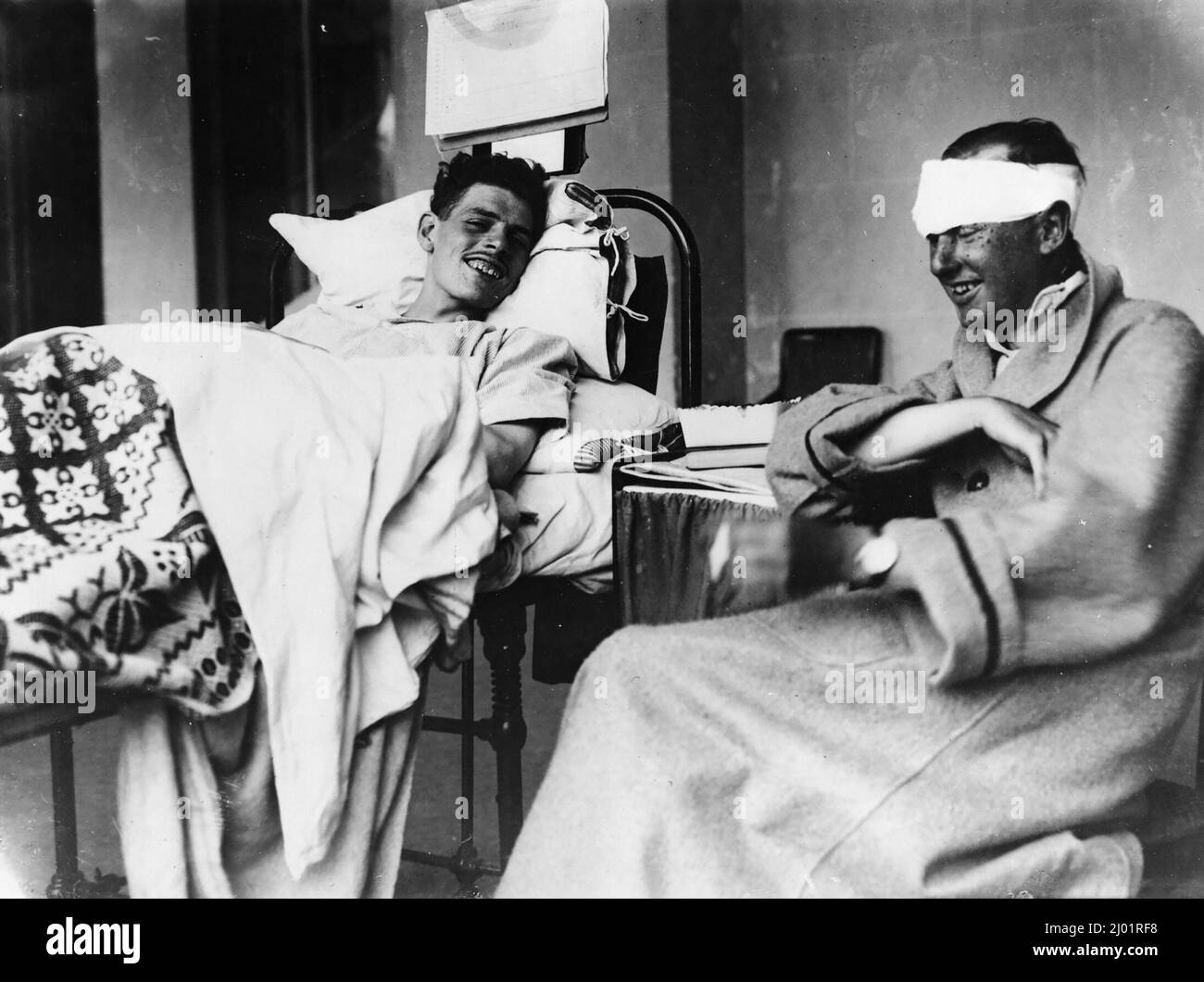 Two injured soldiers in hospital laughing and chatting during WW1 Stock Photo