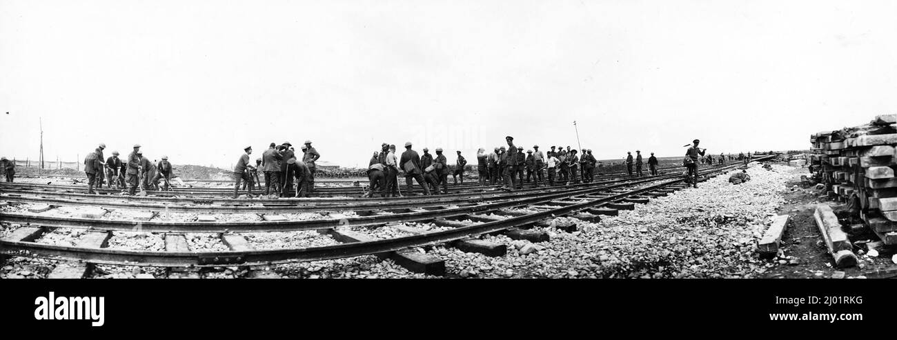A panoramic photo of gangs of men are laying new railway tracks alongside four existing lines on the Western Front. Stock Photo