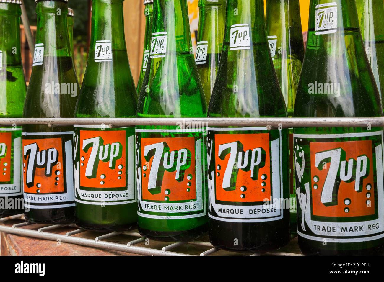 Old English and French language 7 Up soft drink company bottles in