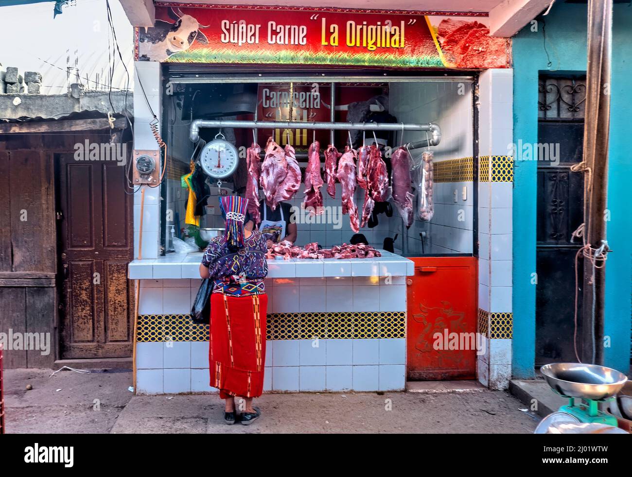 Ixil woman at the butcher, Nebaj, El Quiché, Guatemala Stock Photo