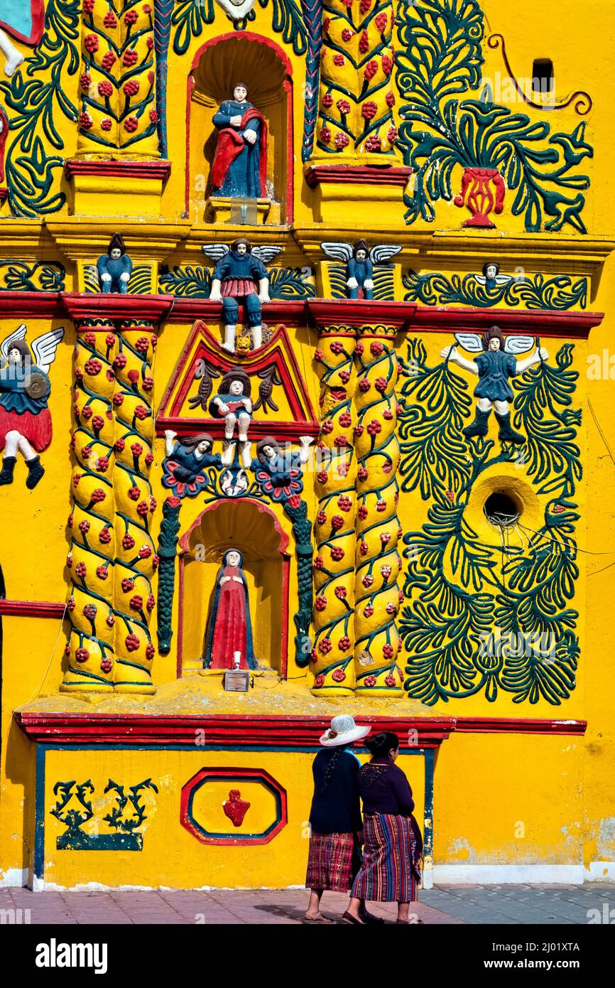 Mayan women at the colorful church of  San Andrés Xecul,, Totonicapán, Guatemala Stock Photo