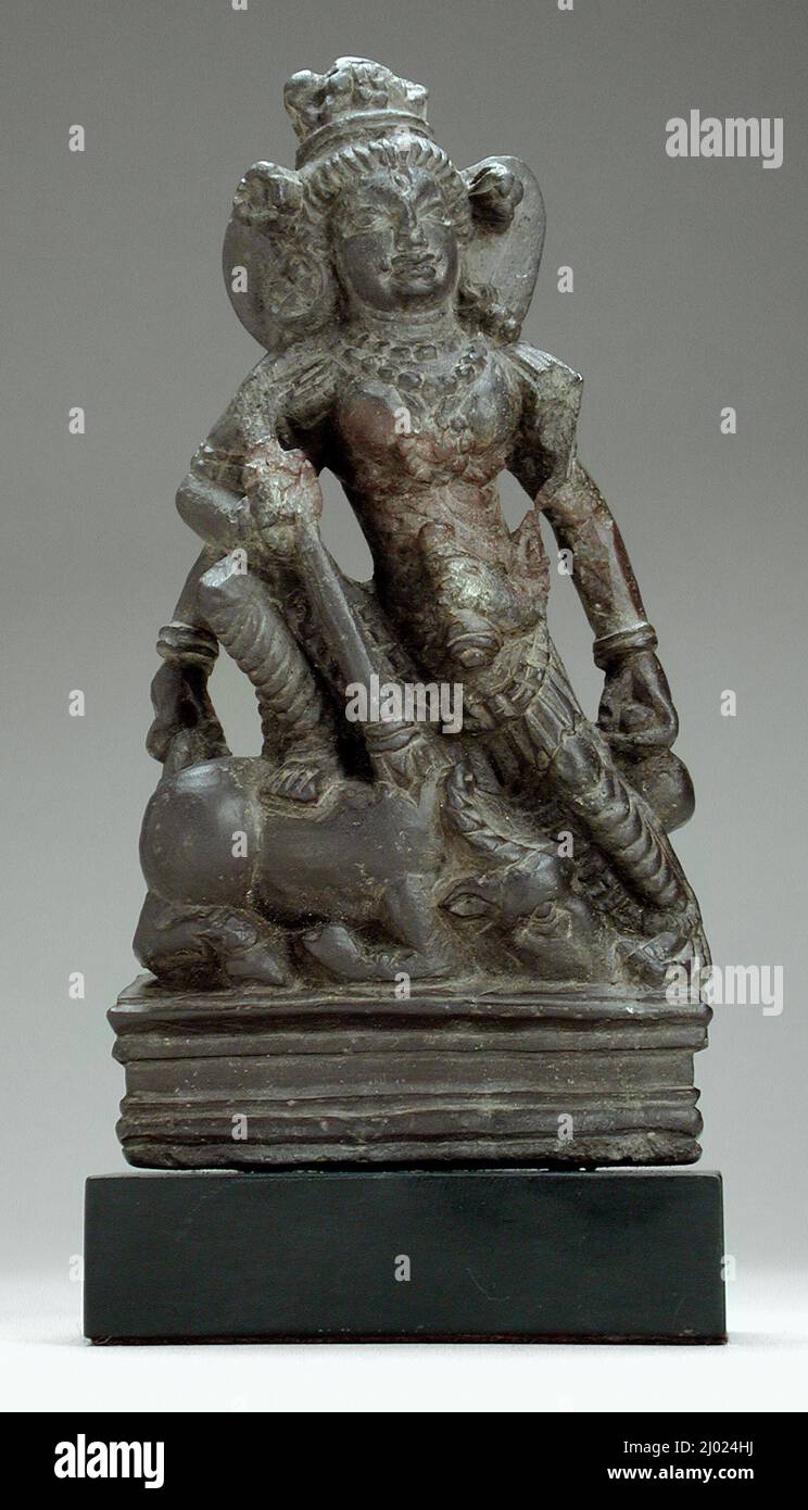 Durga Slaying the Buffalo Demon. India, Jammu and Kashmir, Kashmir region, 7th century. Sculpture. Gray schist Stock Photo