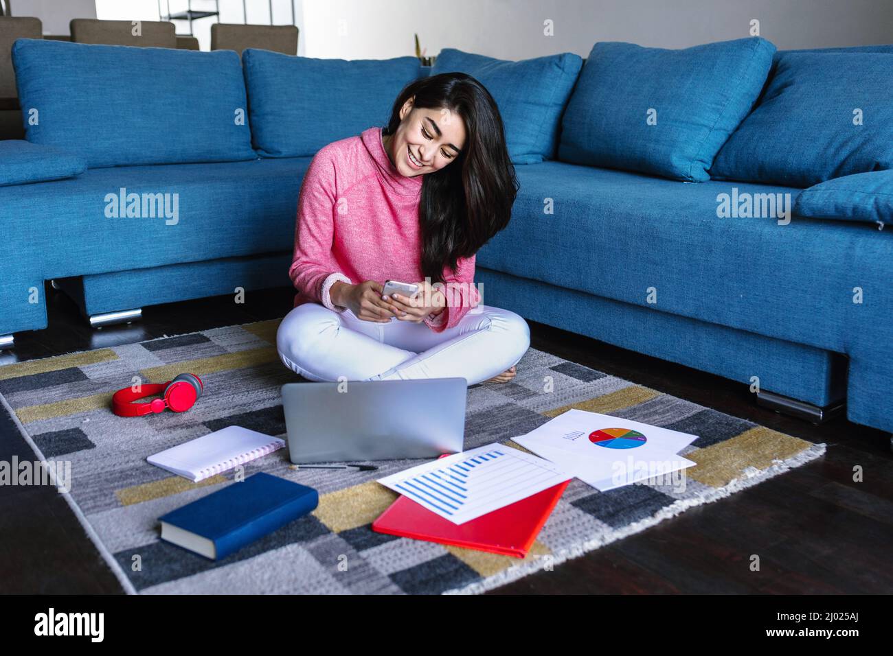 Young hispanic woman working or studying with laptop at home in a home office concept in Mexico Latin America Stock Photo
