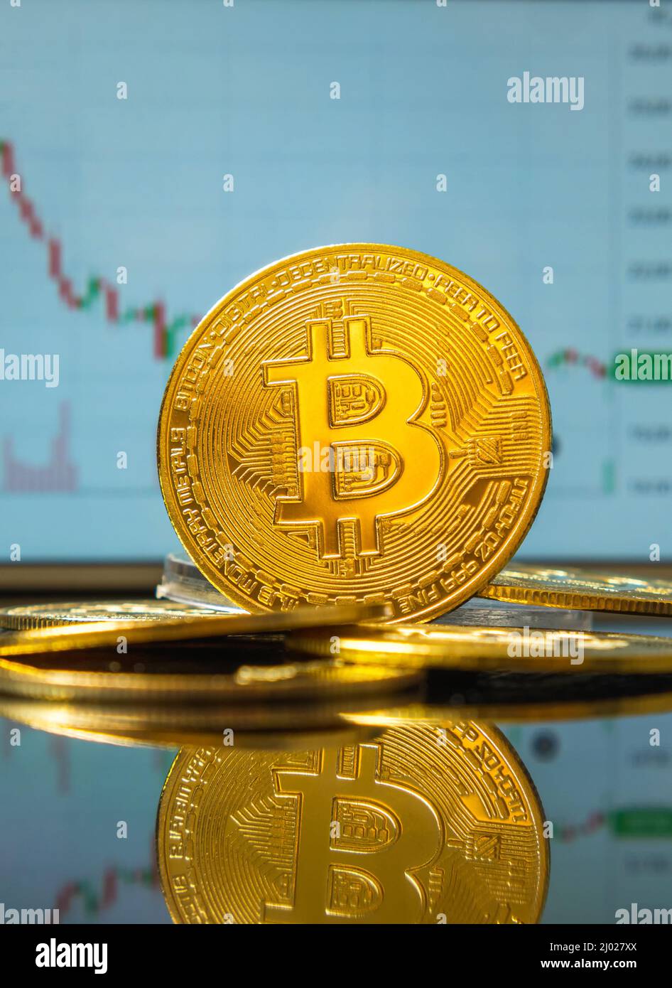 A Bitcoin cryptocurrency coin with a mirror image against the background of  the falling BTC value chart on the exchange. Blockchain technology Stock  Photo - Alamy