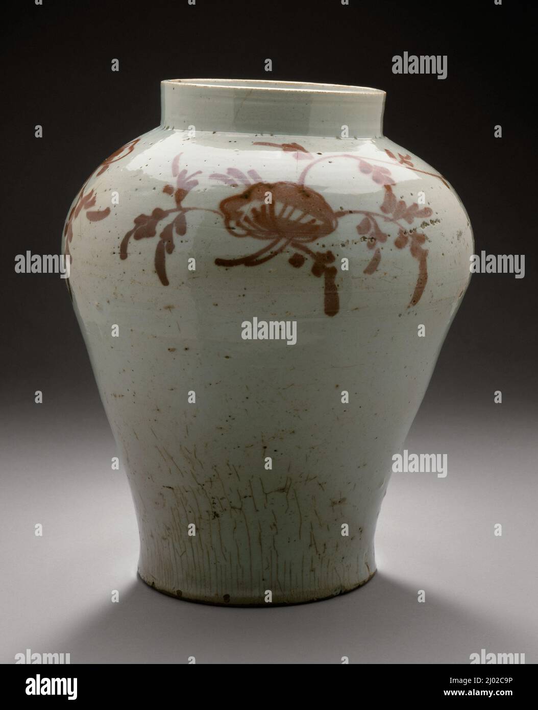 Jar with Underglaze Copper Floral Scroll Design. Korea, Korean, Joseon (1392-1910), 18th century. Furnishings; Serviceware. Wheel-thrown porcelain with red painted decoration under clear glaze Stock Photo