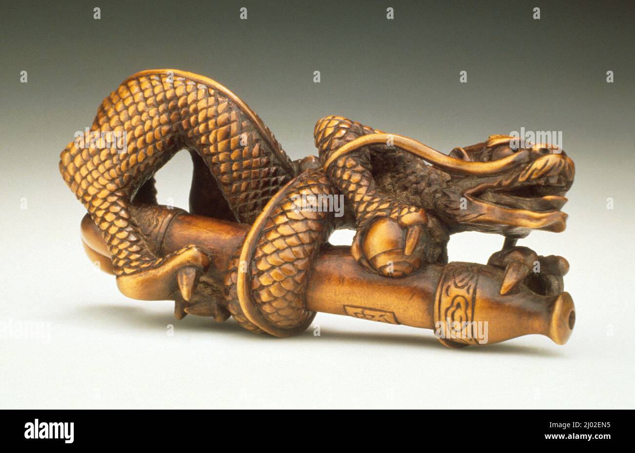Pipe-Smoke Dragon. Shūzan (Japan, active mid-19th century). Japan, mid-19th century. Costumes; costume. Wood with inlays Stock Photo