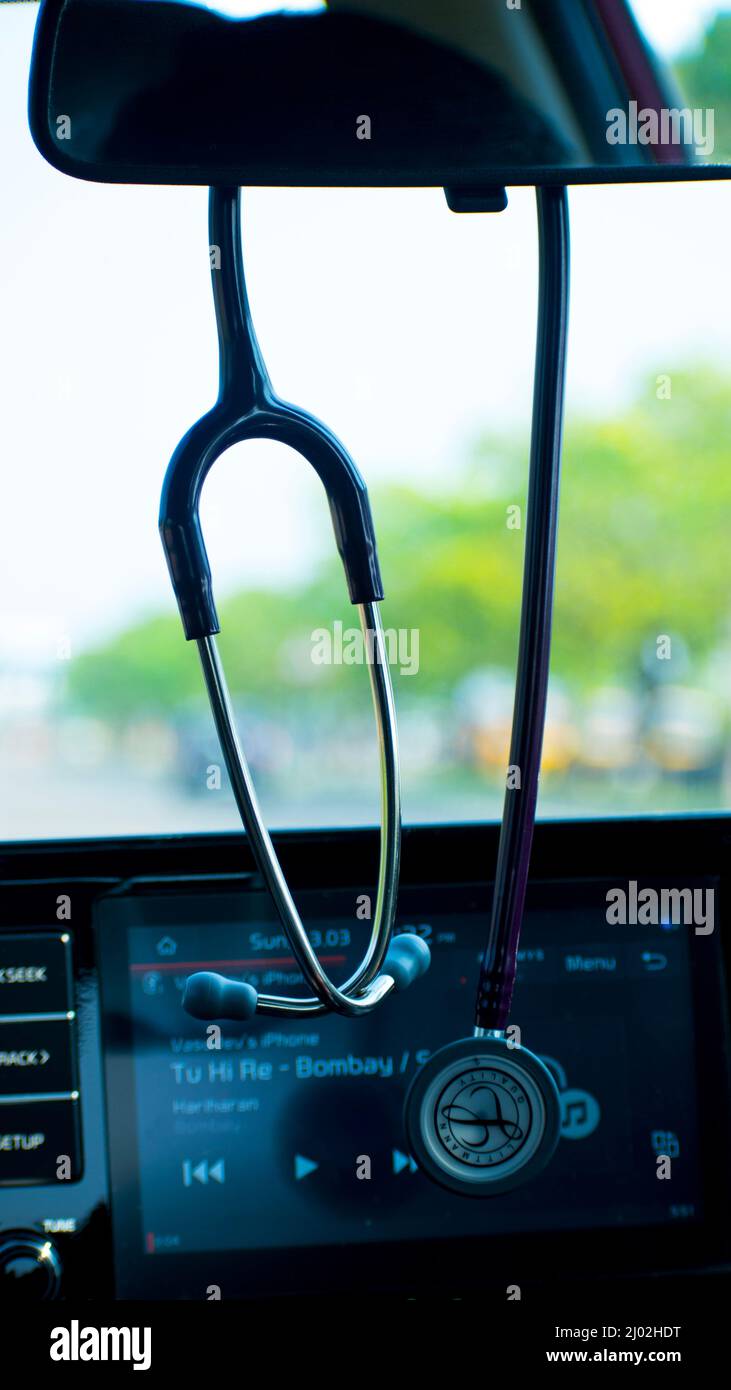 An editorial picture of a Litman stethoscope hanging on a rare view mirror  of a doctor's car Stock Photo - Alamy