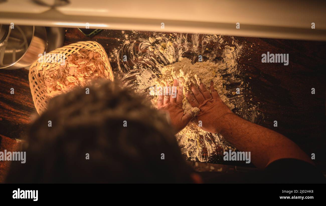 Top view of the professional chef using his hands for grounding a dough ...
