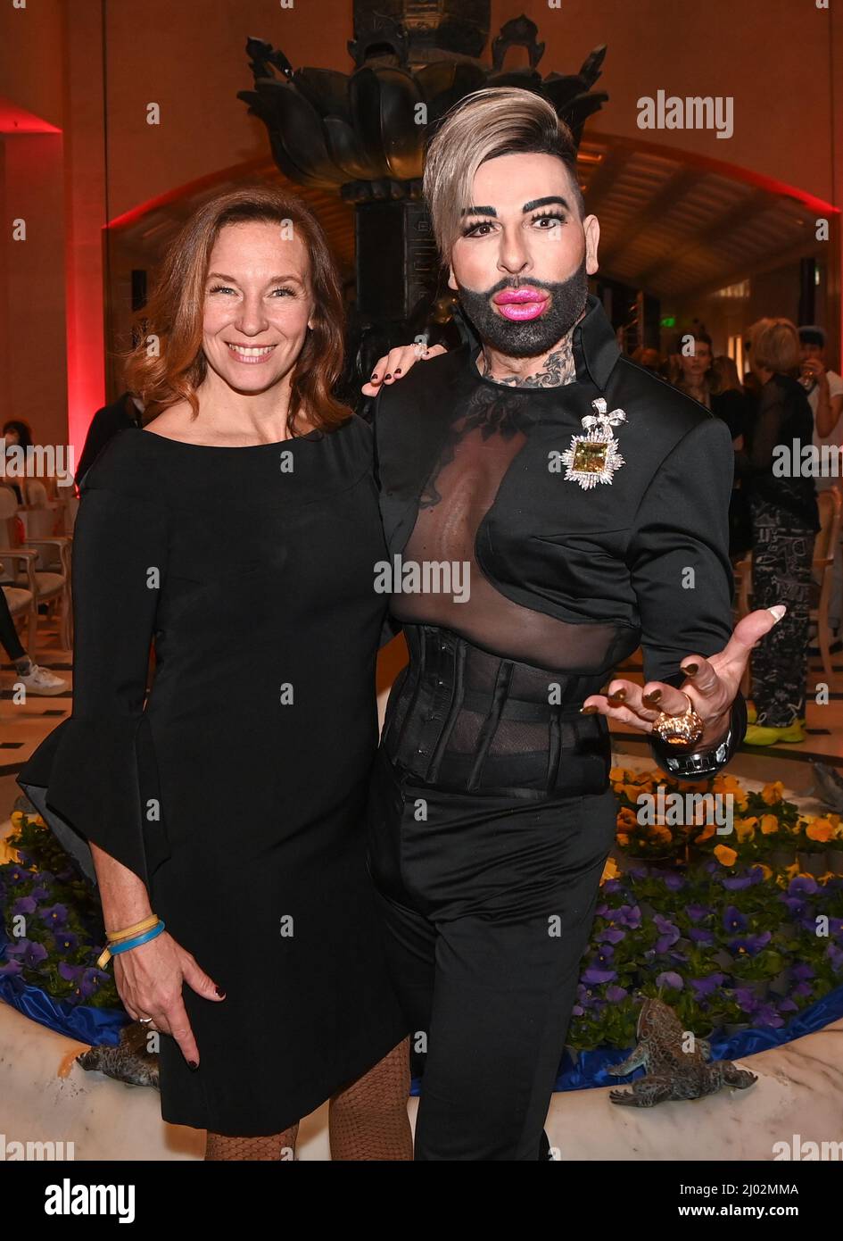 Berlin, Germany. 15th Mar, 2022. Berlin Fashion Week: Designer Anja Gockel and designer Harald Glööckler at the Anja Gockel fashion show at the Adlon Hotel. The Berlin Fashion Week runs from March 14 to 20. Credit: Jens Kalaene/dpa-Zentralbild/dpa/Alamy Live News Stock Photo