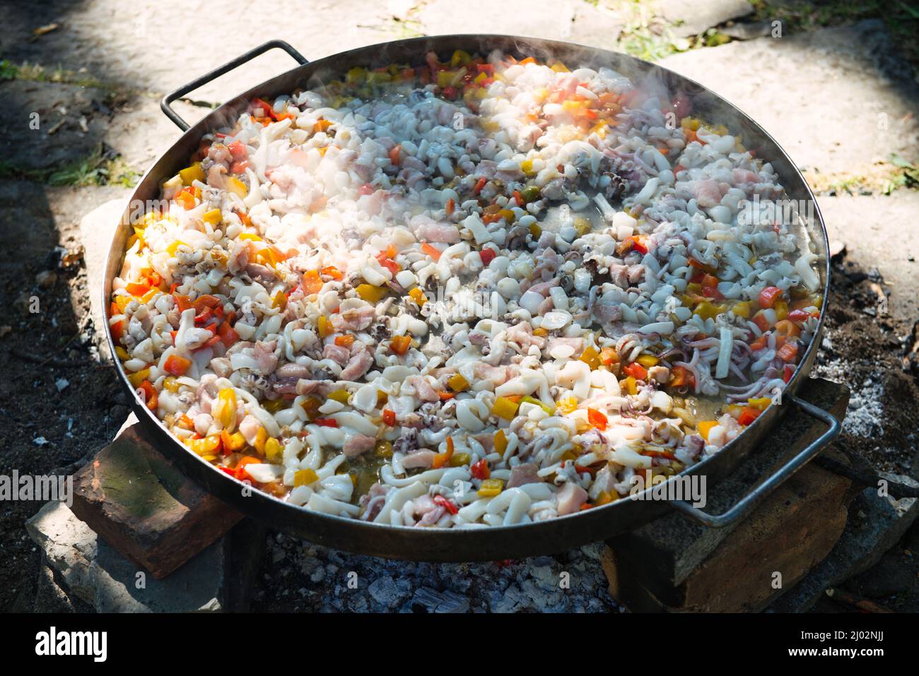 Preparation of Paella in the classic large pan Stock Photo Alamy