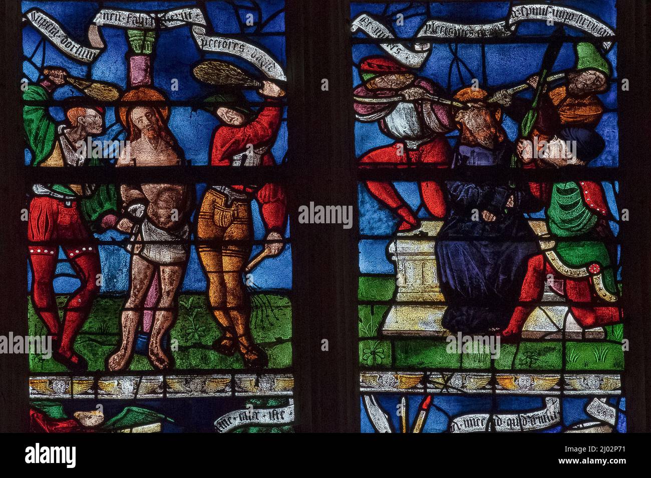 The Flagellation and the Crowning with Thorns: two vivid stained glass panels depicting scenes from the Passion of Christ in a window of 1511, created by the master glassmakers of Troyes, in the Église Saint-Rémi at Ceffonds, a village in the Haute-Marne department of the Champagne region in northeast France. Stock Photo