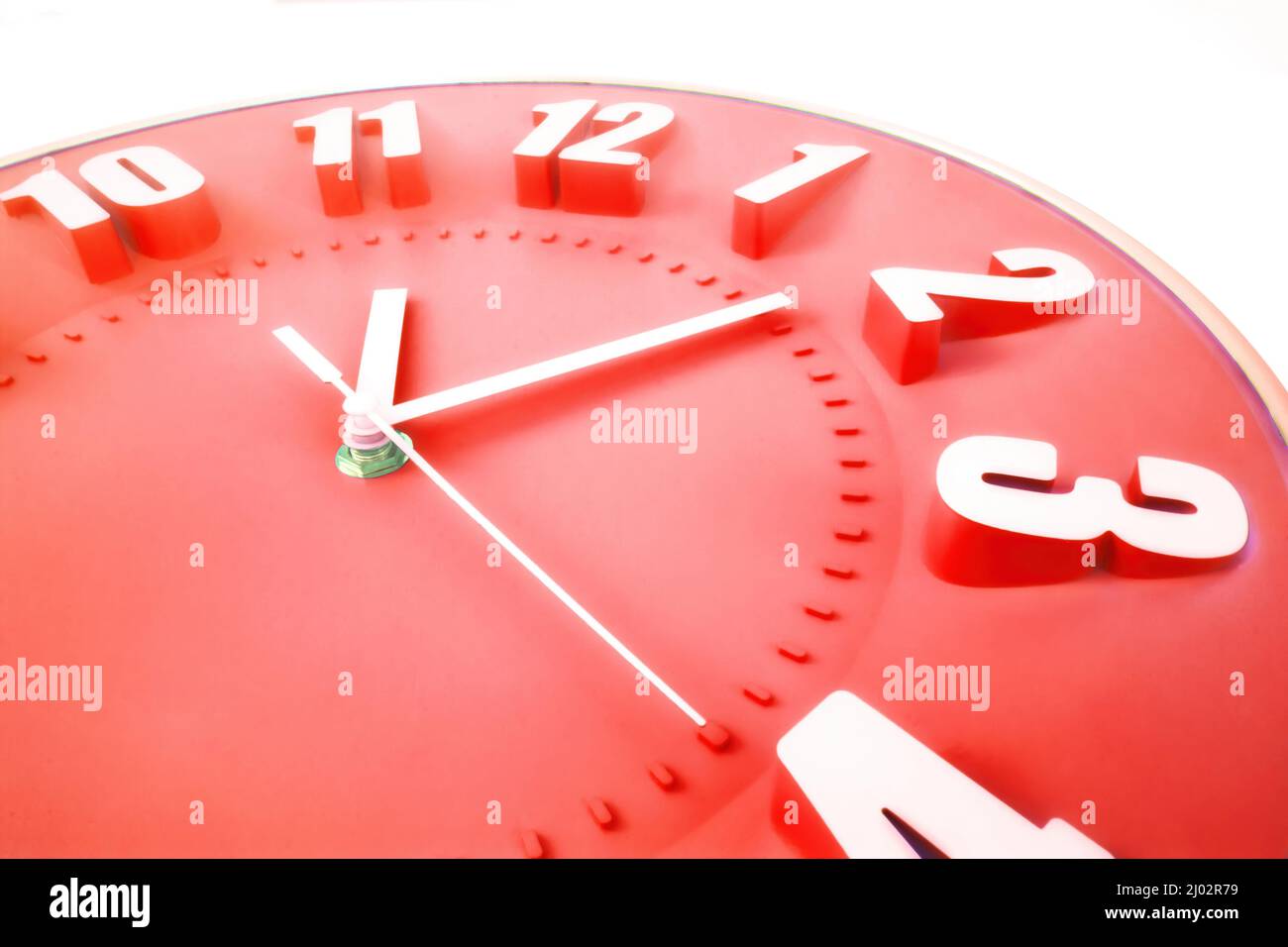 Red clock face with 3D numbers and second hand on a pure white background Stock Photo