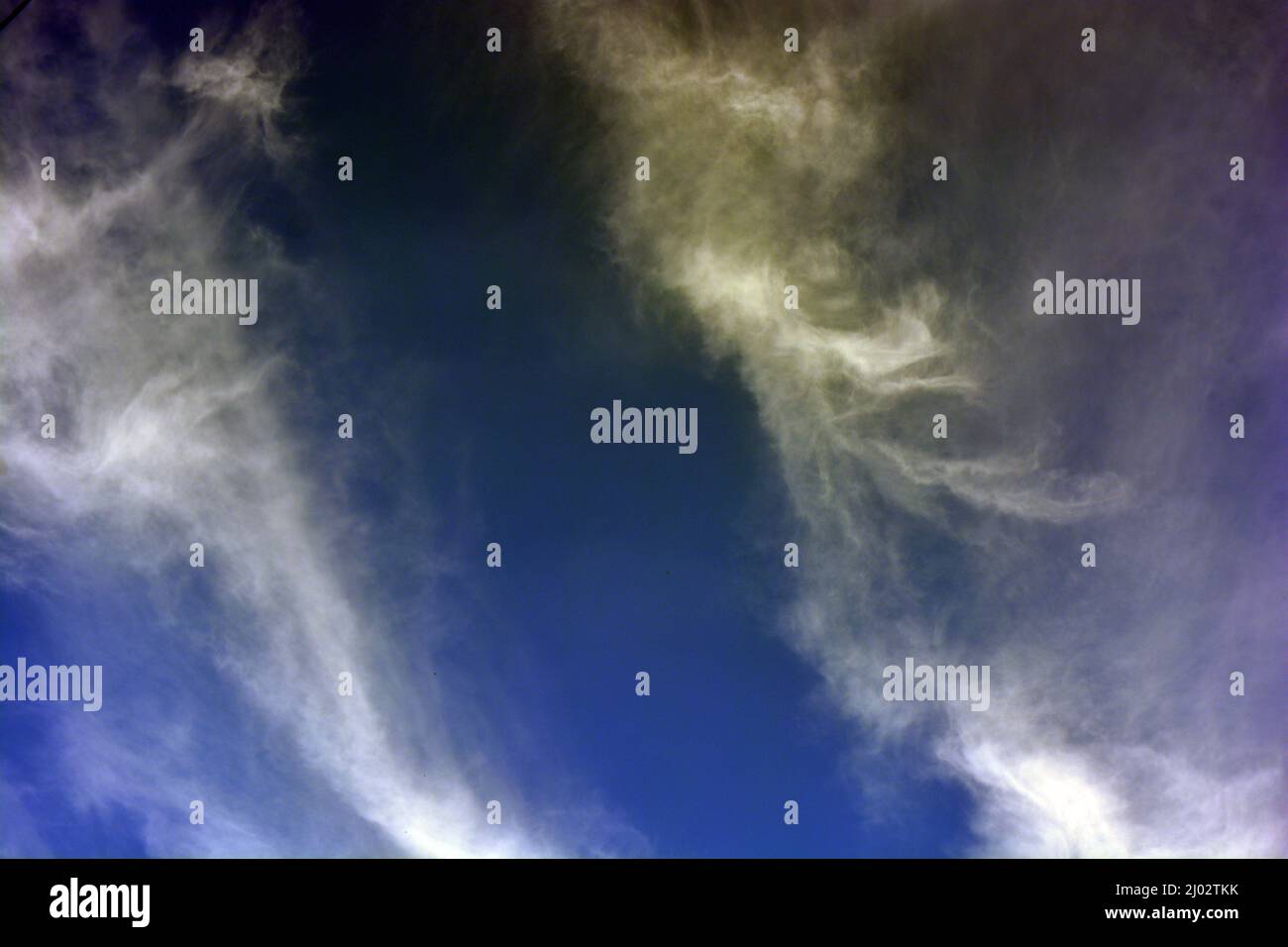 Beautiful and unusual nature, bright dark blue sky with small white clouds. Stock Photo