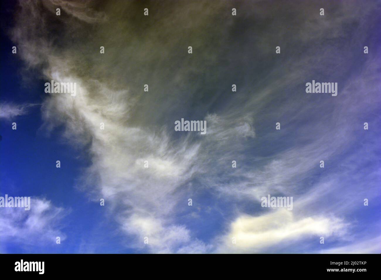 Beautiful and unusual nature, bright dark blue sky with small white clouds. Stock Photo
