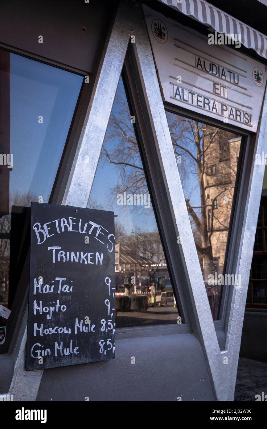 funny board of a pub in the old part of the town, Cologne, Germany, (translation: assisted drinking). lustige Tafel an einer Kneipe in der Altstadt, B Stock Photo