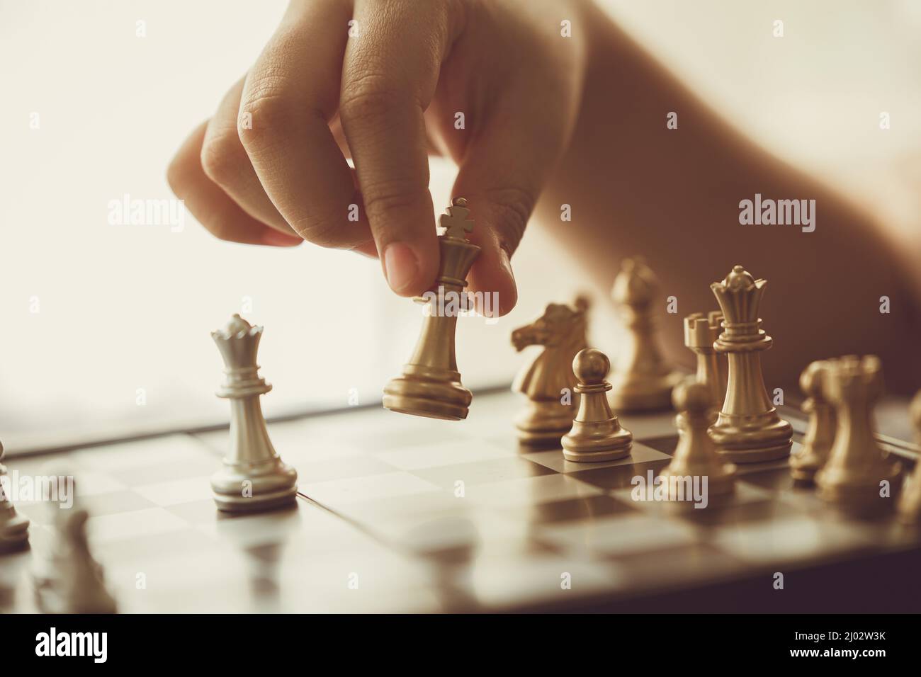 closeup hand playing chess moving chesspiece step forward Stock Photo