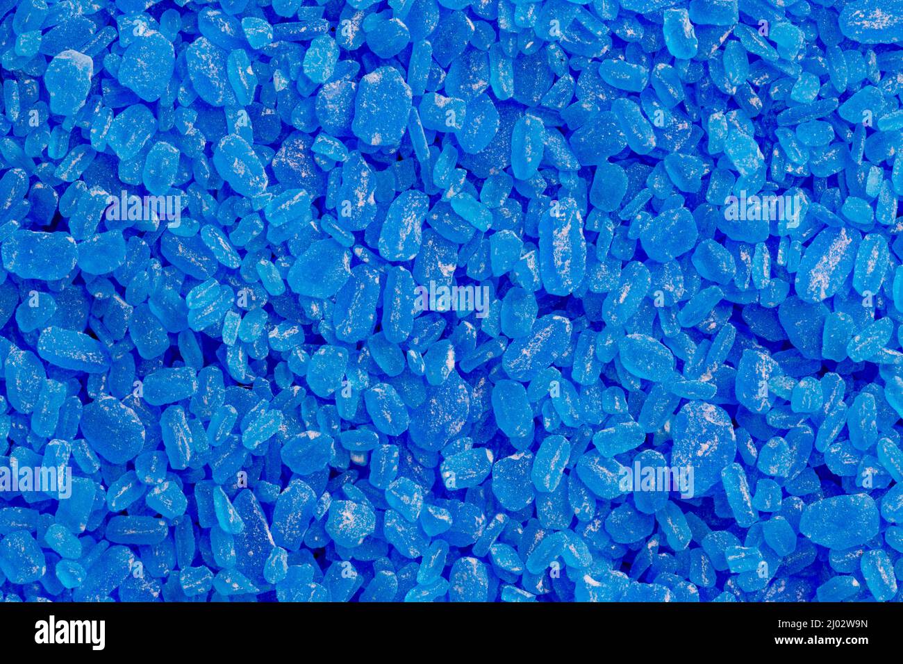 full frame background and texture of blue copper sulfate granules - close-up Stock Photo