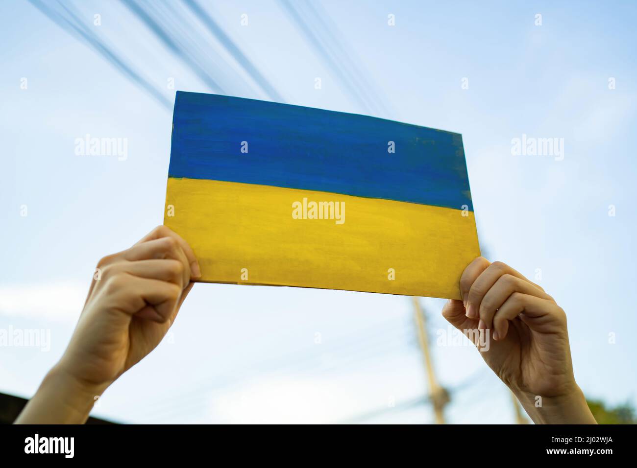 A man holding cardboard painted into Ukraine flag Stock Photo