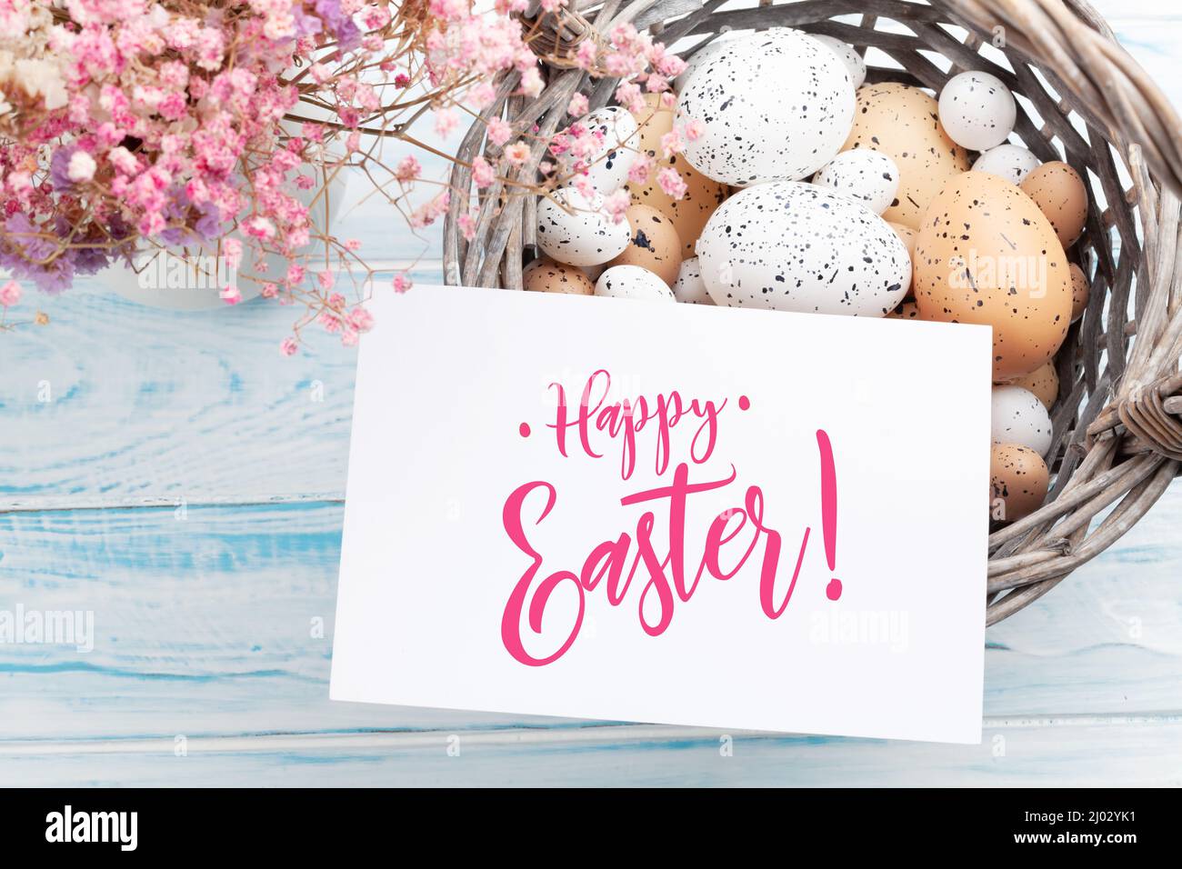 Easter greeting card with easter eggs and flowers. Top view flat lay ...