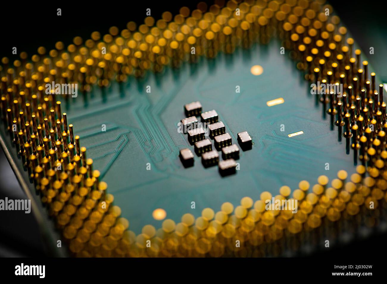 Macro Close up of microchips and pins on Main CPU PC processor circuit board. Stock Photo