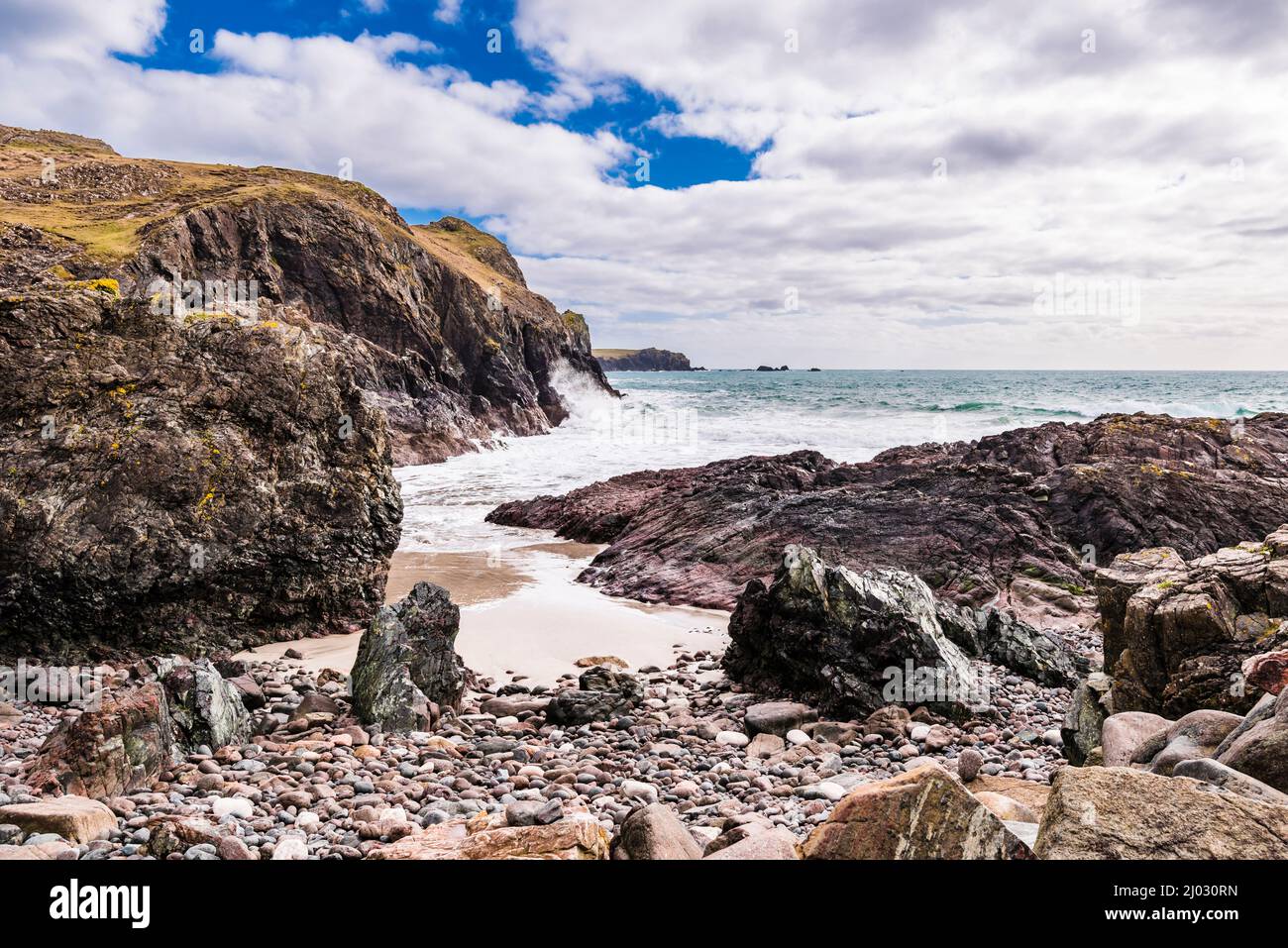 Surf breaking on the sands at low tide in Kynance Cove, Lizard