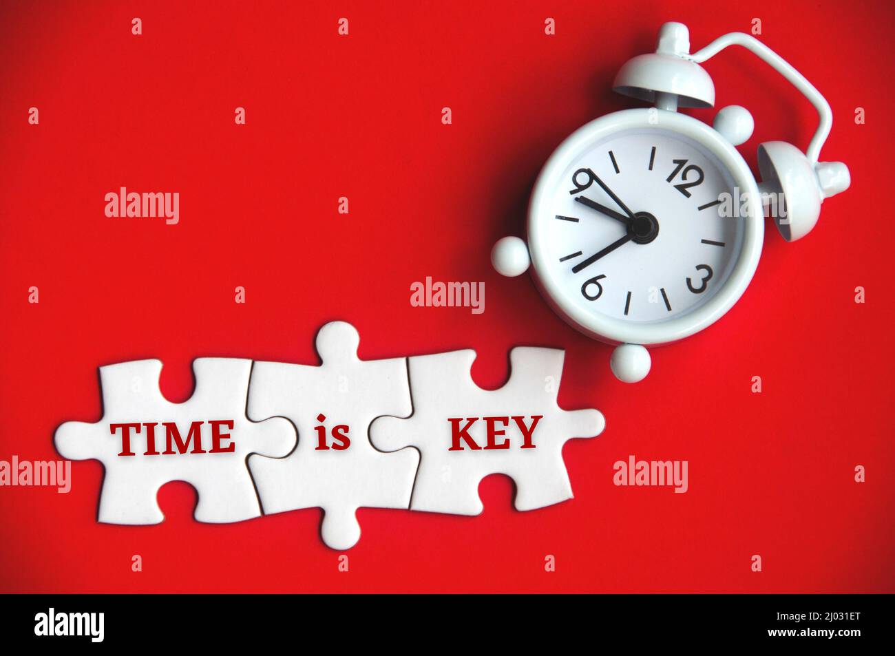 Text on missing jigsaw puzzle with alarm clock background Time is key