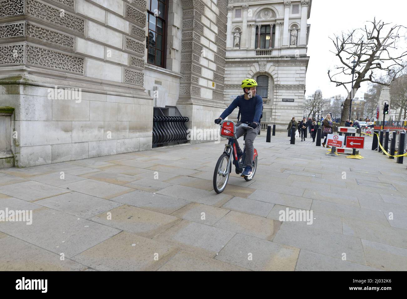 London, England, UK. Cycling on the pavement in Whitehall, Westminster Stock Photo