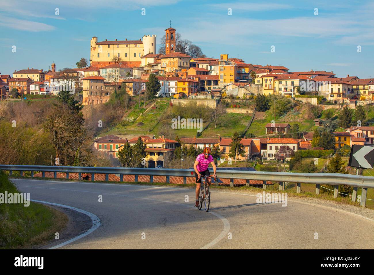 Cyclist leaving Cortanze, Piedmont, Italy, Europe Stock Photo