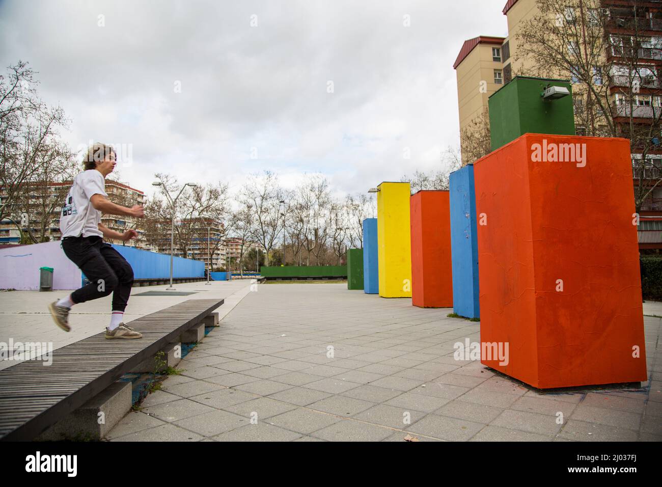 series of photos of young man jumping practicing parkour in the street