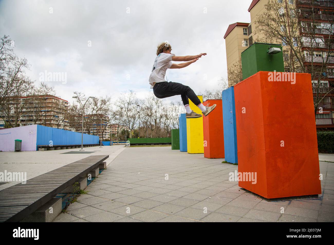 series of photos of young man jumping practicing parkour in the street