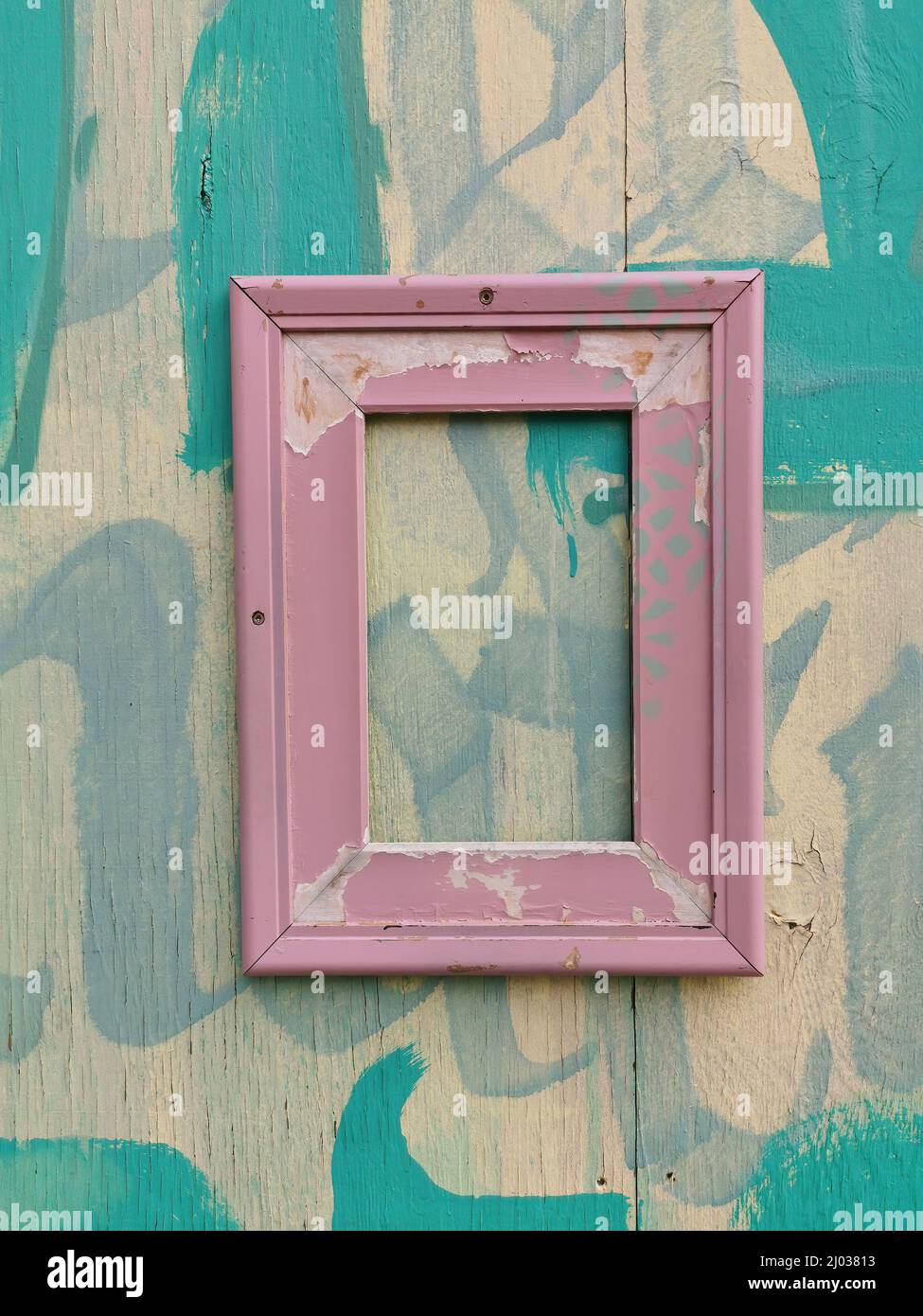 verwitterter Bilderrahmen an einer Holzwand  /  weathered picture frame on a wooden wall Stock Photo