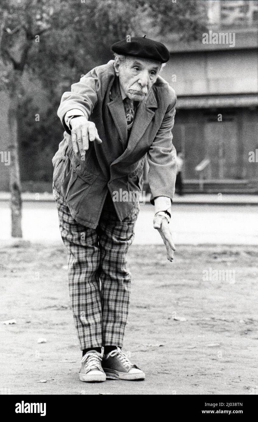 A very dapper older man, likely Italian American, exerts some body english during a bocce game in Midtown Manhattan, New York City. 1978. Stock Photo