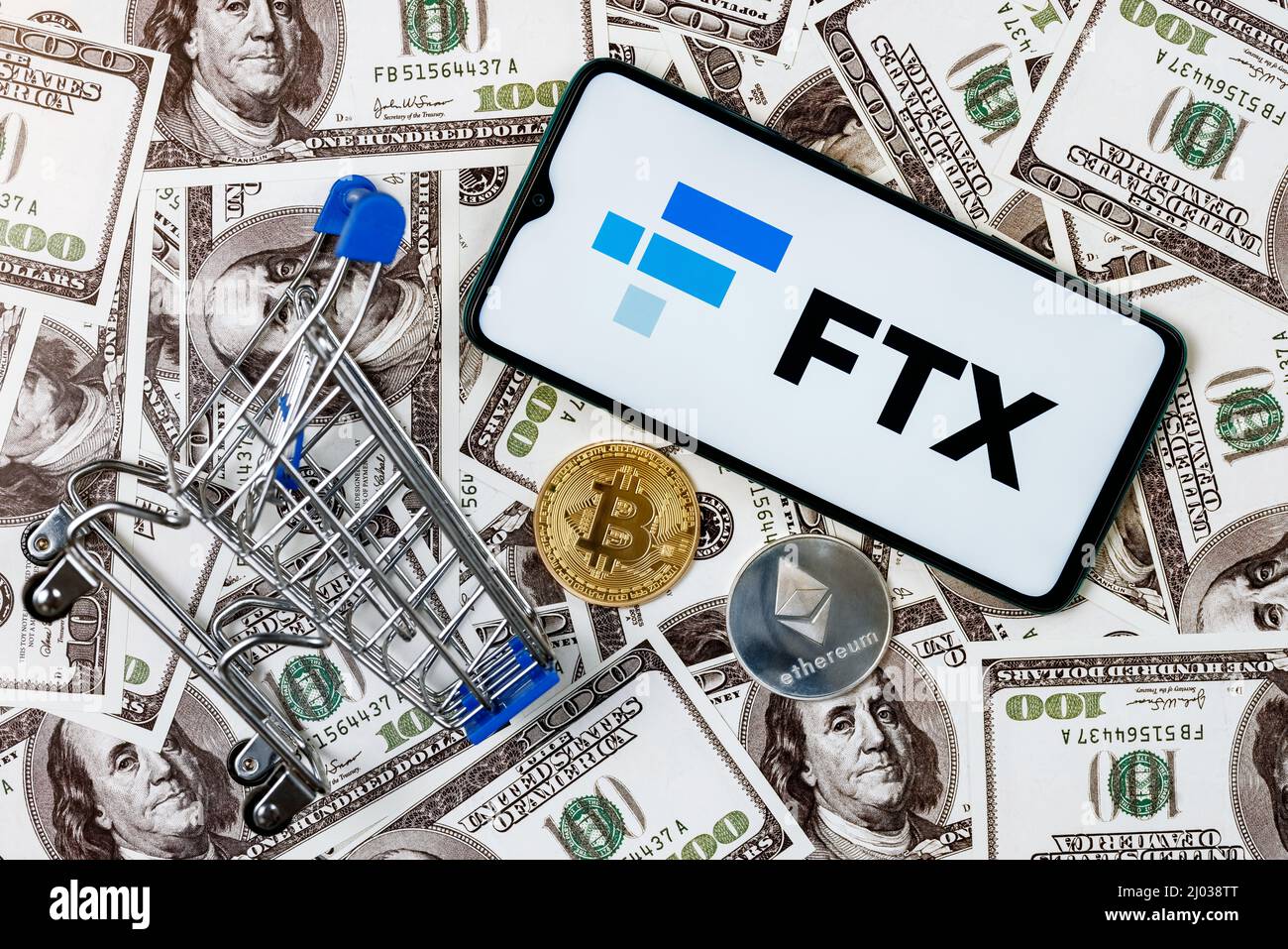 FTX is a cryptocurrency exchange. A smartphone with the FTX logo, a  shopping cart and a cryptocoins on the dollar bills Stock Photo - Alamy