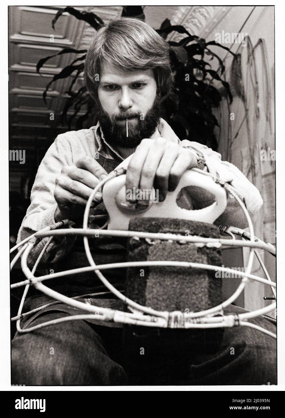 A young man, perhaps a student or an intern, helps builds a puppet in the studio of the legendary puppet builder, Kermit Love. It was for a foreign country's version of Sesame Street. 1978 in Greenwich Village, Manhattan, on Great Jones Street. Stock Photo