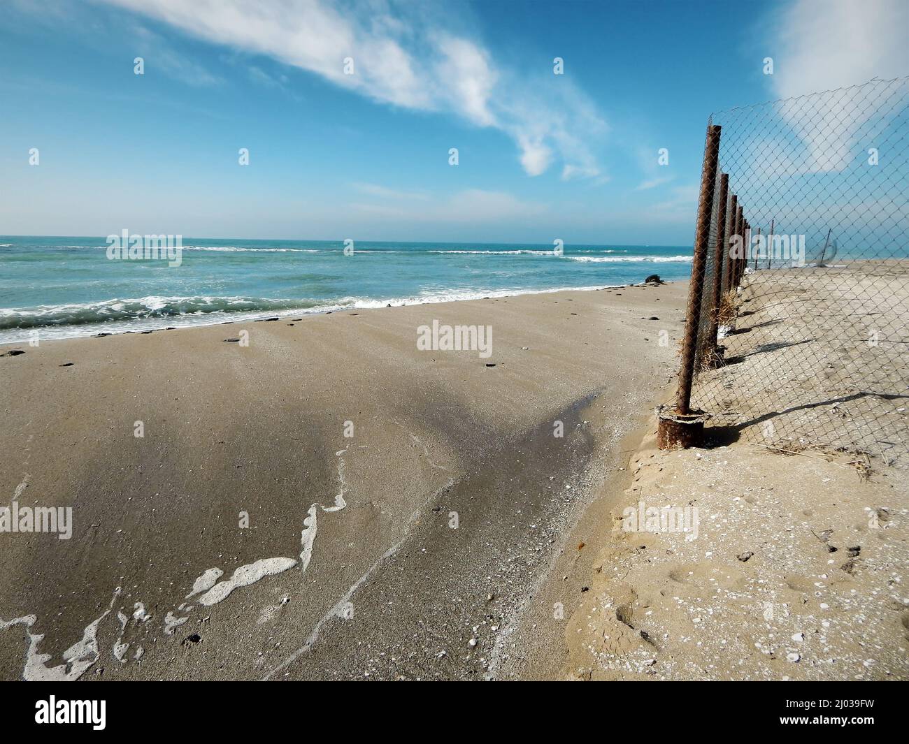 Sandy coast of the Caspian Sea. Mesh fence. Kazakhstan. Mangistau region. 04 February. 2020 year. Stock Photo