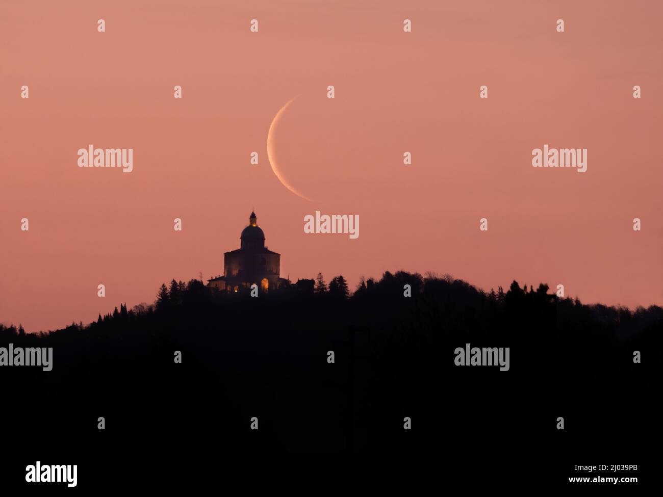 Waning crescent moon at sunrise above San Luca Sanctuary, Bologna, Emilia Romagna, Italy, Europe Stock Photo