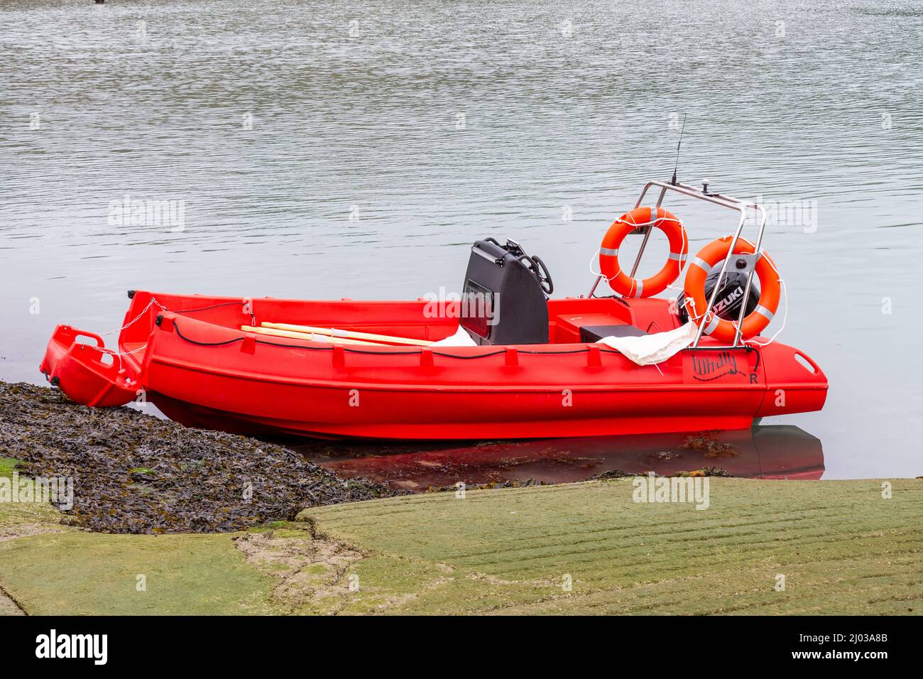 Whaly Polyethylene red boat beached on slipway Stock Photo