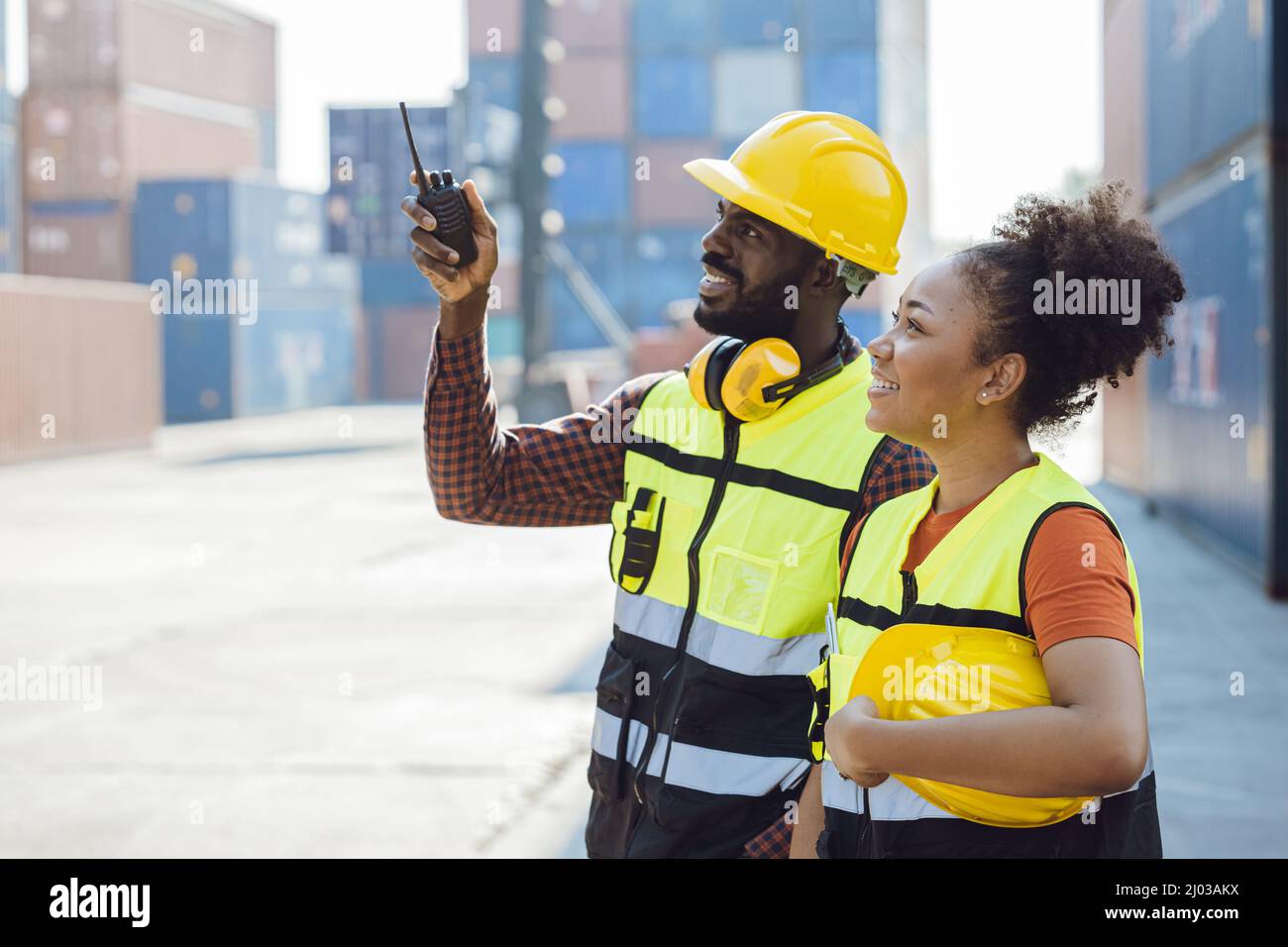 male staff worker working together  with women team in shipping cargo port Stock Photo