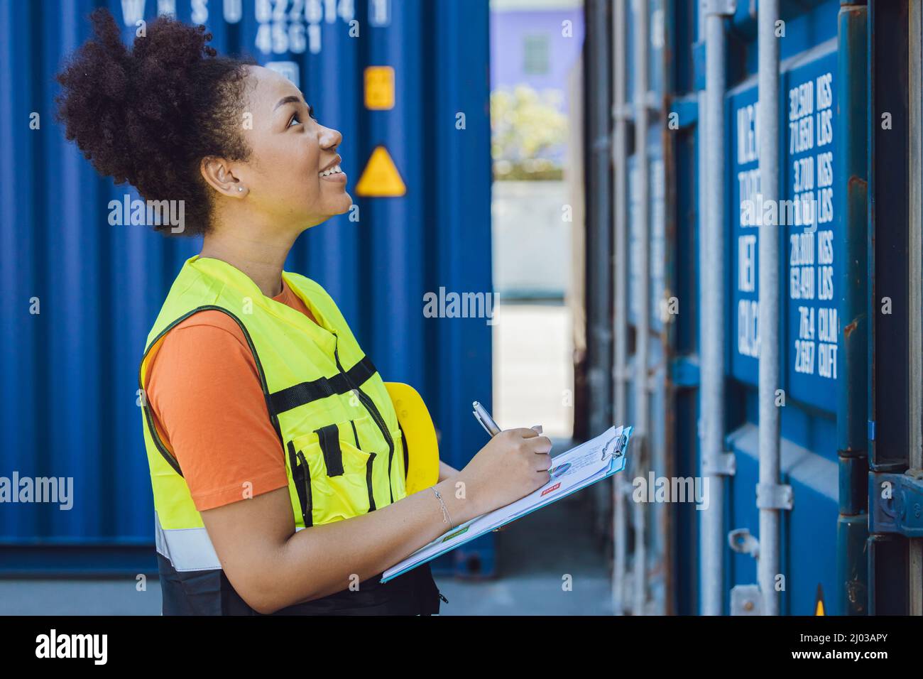 working women happy staff worker  enjoy work checking container for delivery in logistic industry Stock Photo