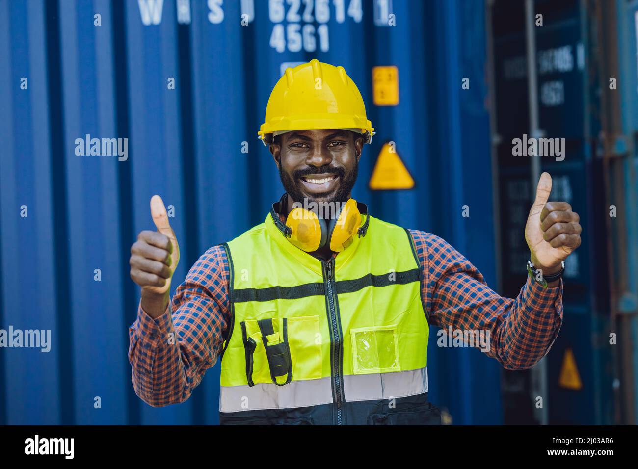Portrait staff worker thumbs up happy working in port cargo shipping logistic industry Stock