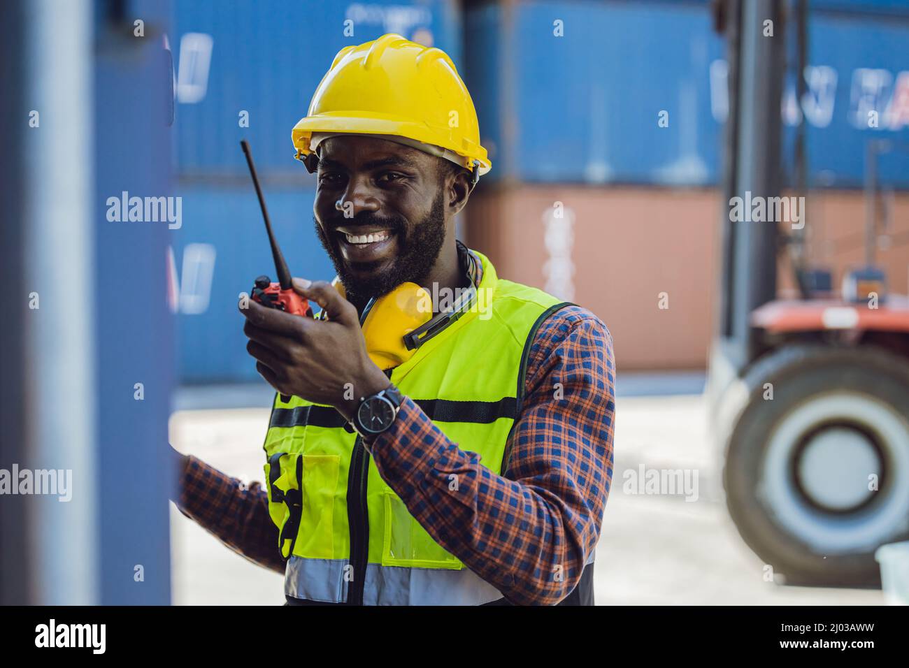 happy worker working in port logistic cargo industry with radio command Stock Photo