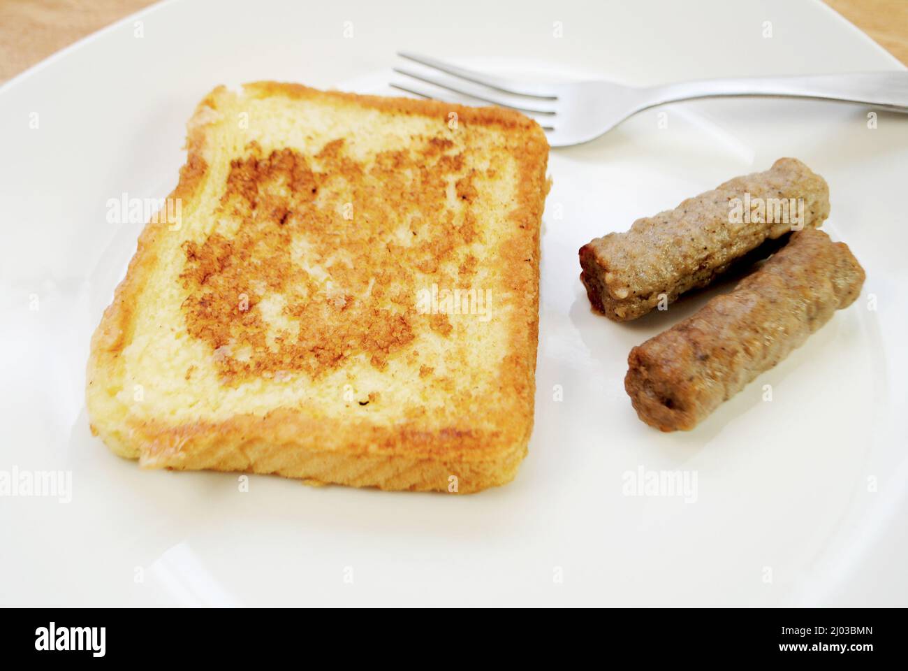 Fried French Toast served on a Plate with Two Sausage Links Stock Photo