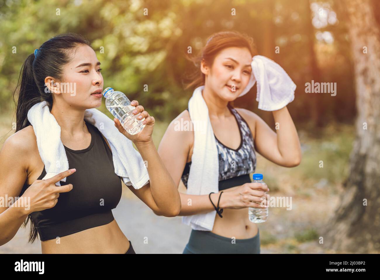 healthy sport women thirsty drinking water during exercise in hot summer season Stock Photo