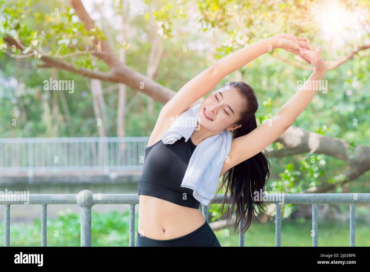 healthy woman morning exercise fitness with fresh green tree park outdoor background Stock Photo