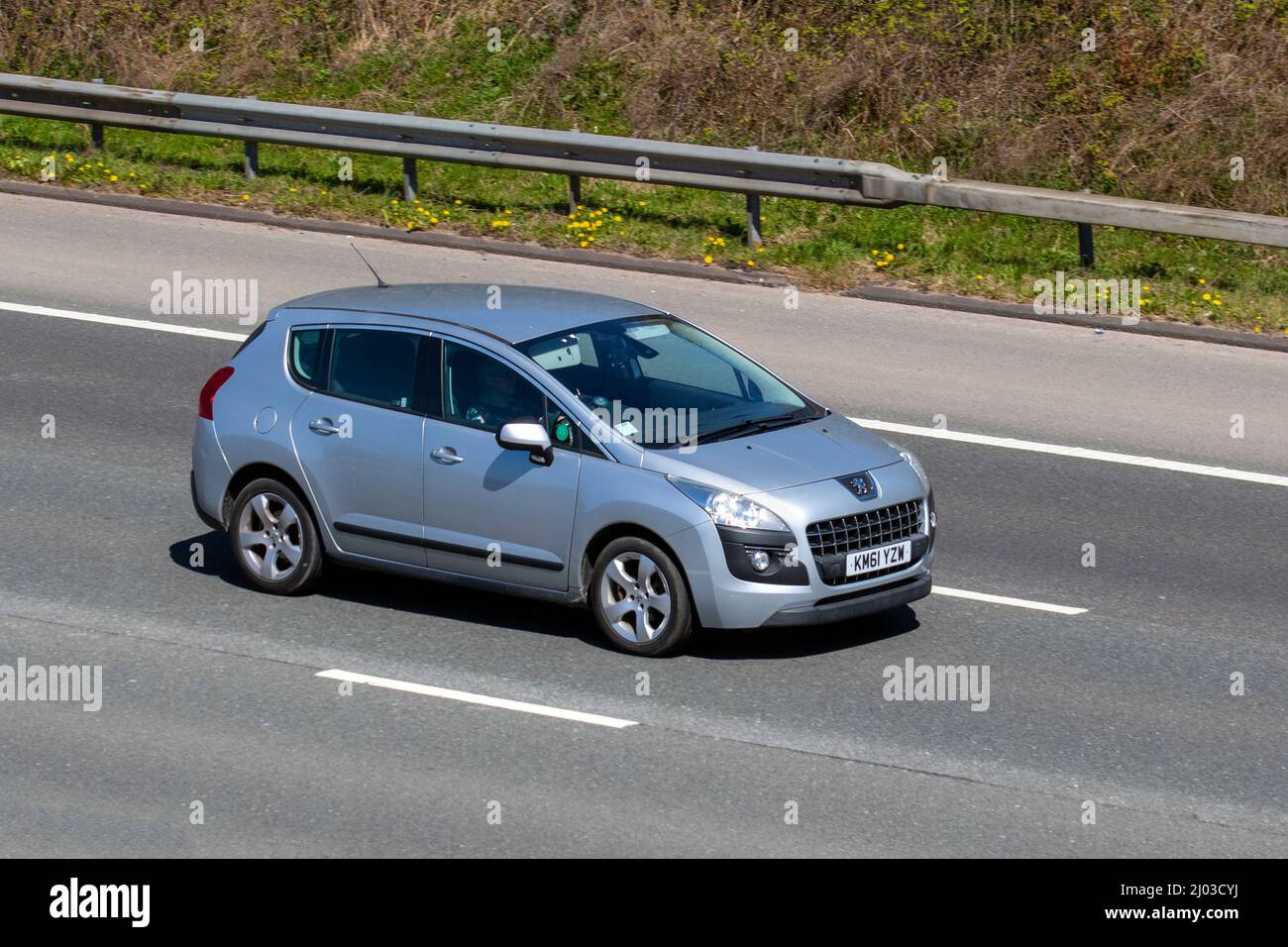 2012 silver Peugeot 3008 E-HDI Active 1560cc 6 speed automatic 4dr driving on the M61 Motorway, Manchester, UK Stock Photo