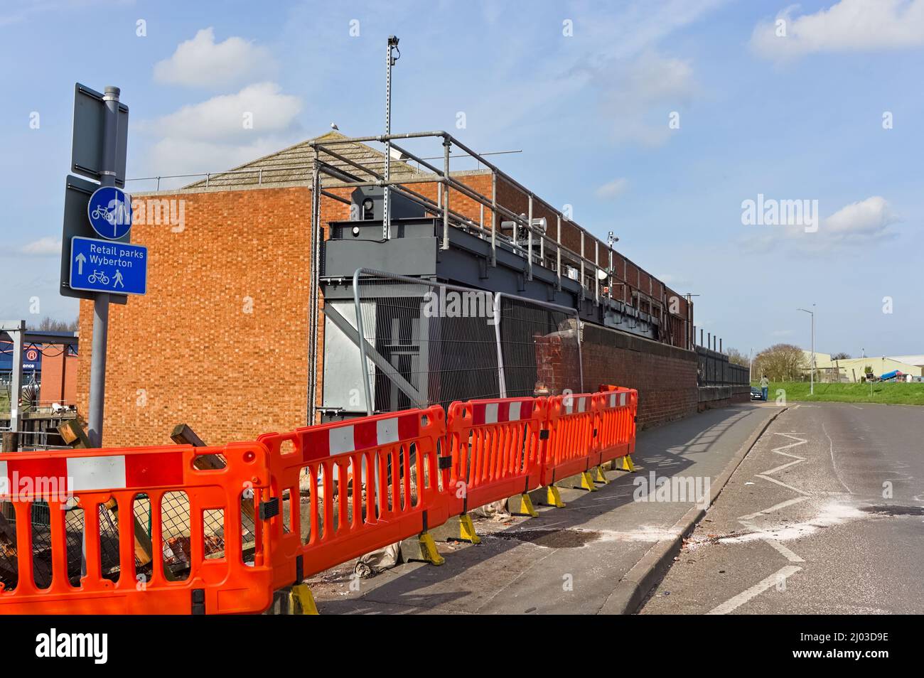 orange barriers used to cordon off the damaged bridge by the old pumping station on London Rd. Boston Stock Photo