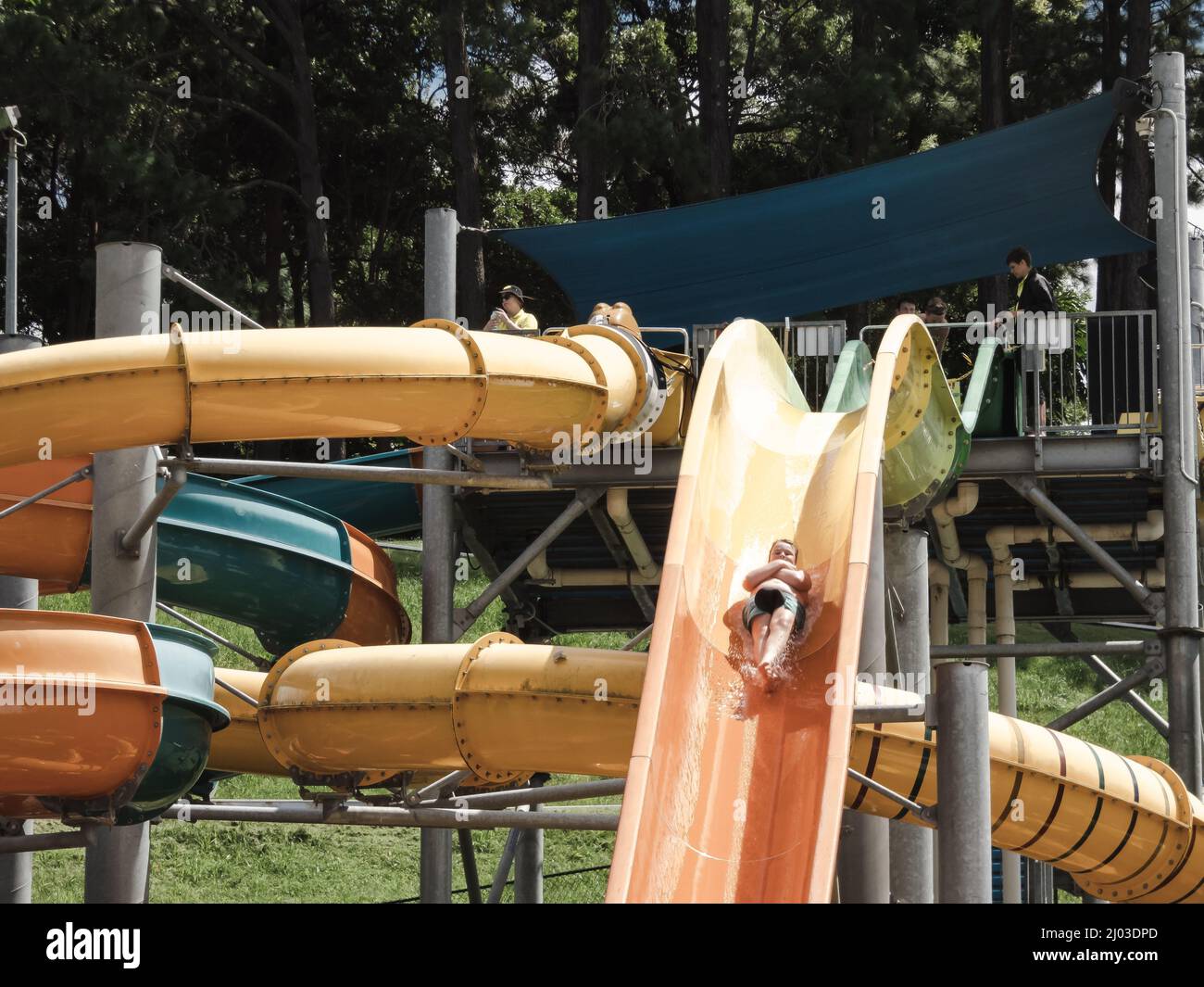 Kids having fun riding water slides on summer vacation in Coffs Harbour