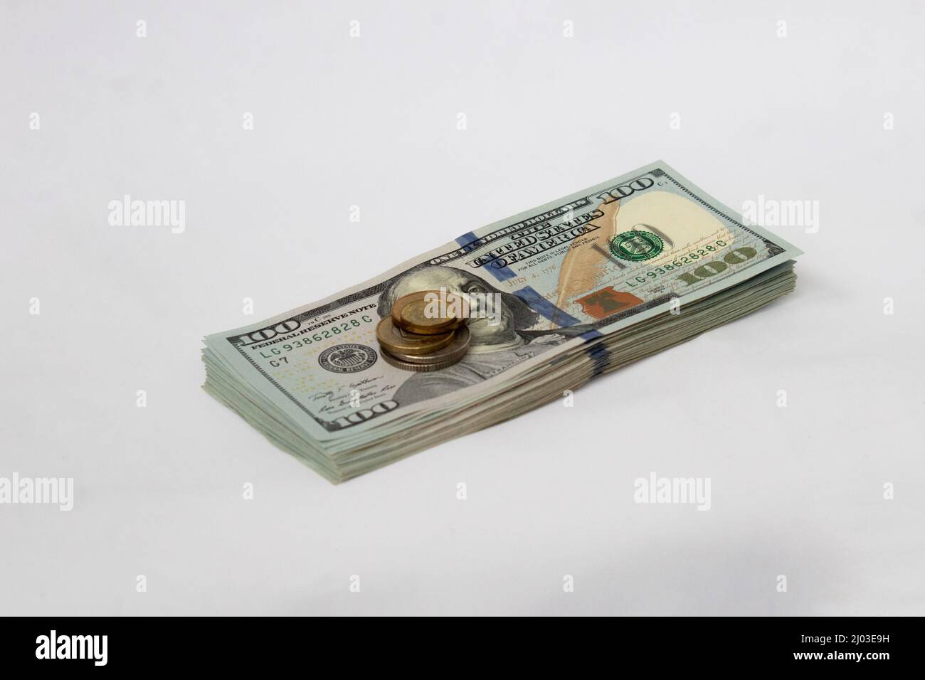 A stack of hundred-dollar bills on a white isolated background. 100 dollar bills Stock Photo