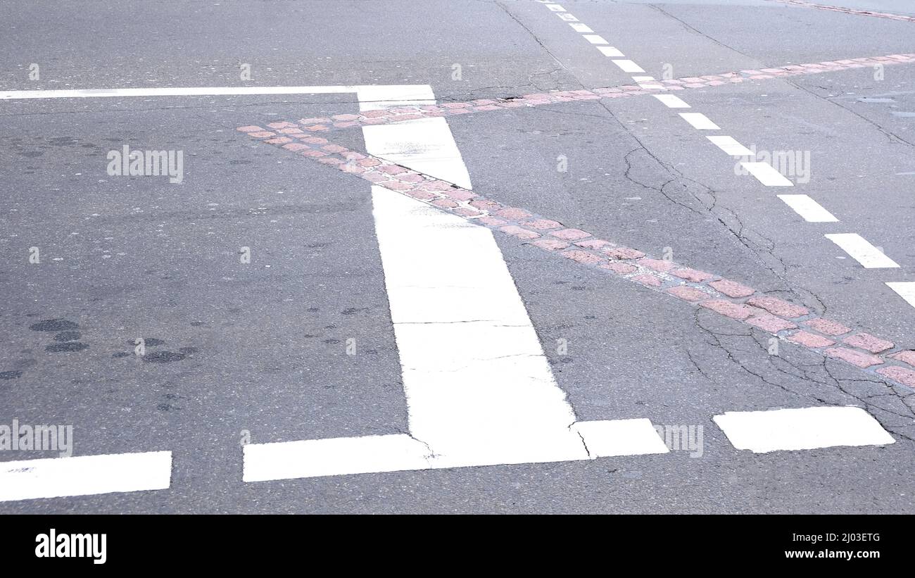 Berlin, Germany, road marking with stop line crossed by marked border line of former German division Stock Photo