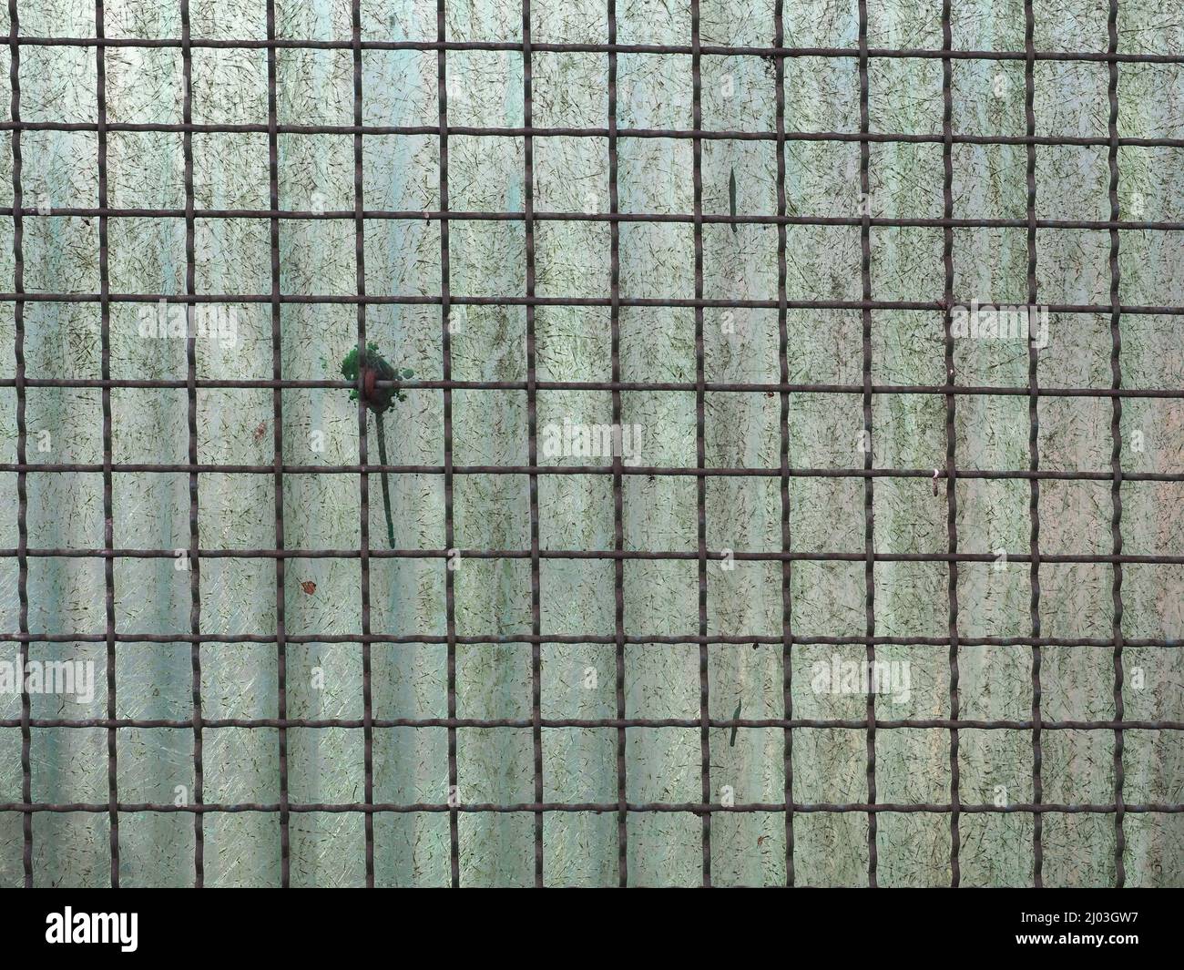 metal net and corrugated plastic fence useful as a background Stock